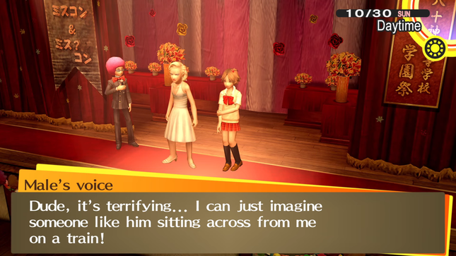 An in game screenshot from Persona 4 Golden. Kanji and Yosuke are currently on a stage with a male NPC on their left. The NPC is holding a microphone and is wearing a bright pink afro. Kanji is currently dressed like Marilyn Monroe, he has a blonde wig and white dress on. Yosuke is wearing small pigtails, a blouse, and a skirt. They are standing in front of an audience that is mostly blocked by a textbox. An offsreen character is currently speaking, they have no character sprite. The textbox at the bottom of the screen reads: 'Dude, it's terrifying... I can just imagine someone like him sitting across from me on a train!'.